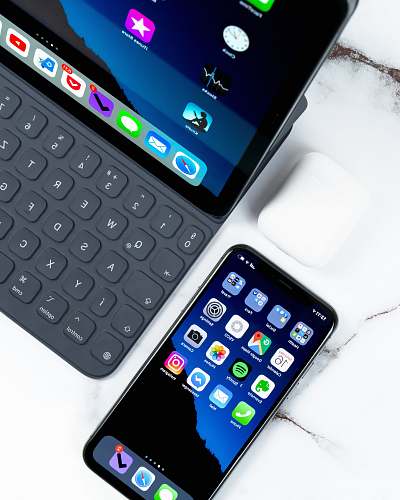 cell phone black smartphone near tablet computer on white surface electronics